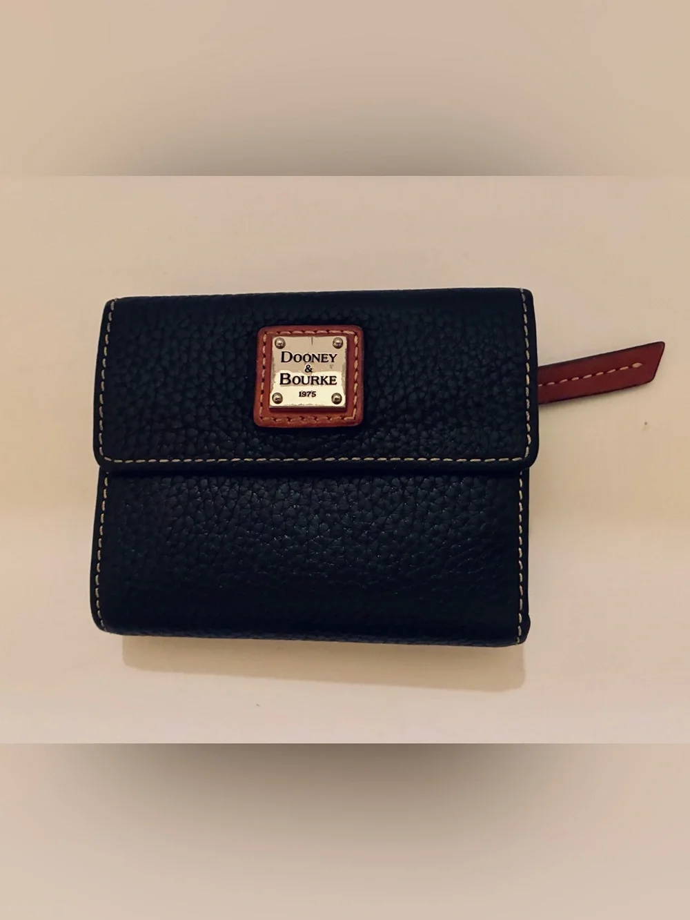 Dooney & Bourke Black Pebbled Leather Wallet with Brown Trim and Gold Plaque